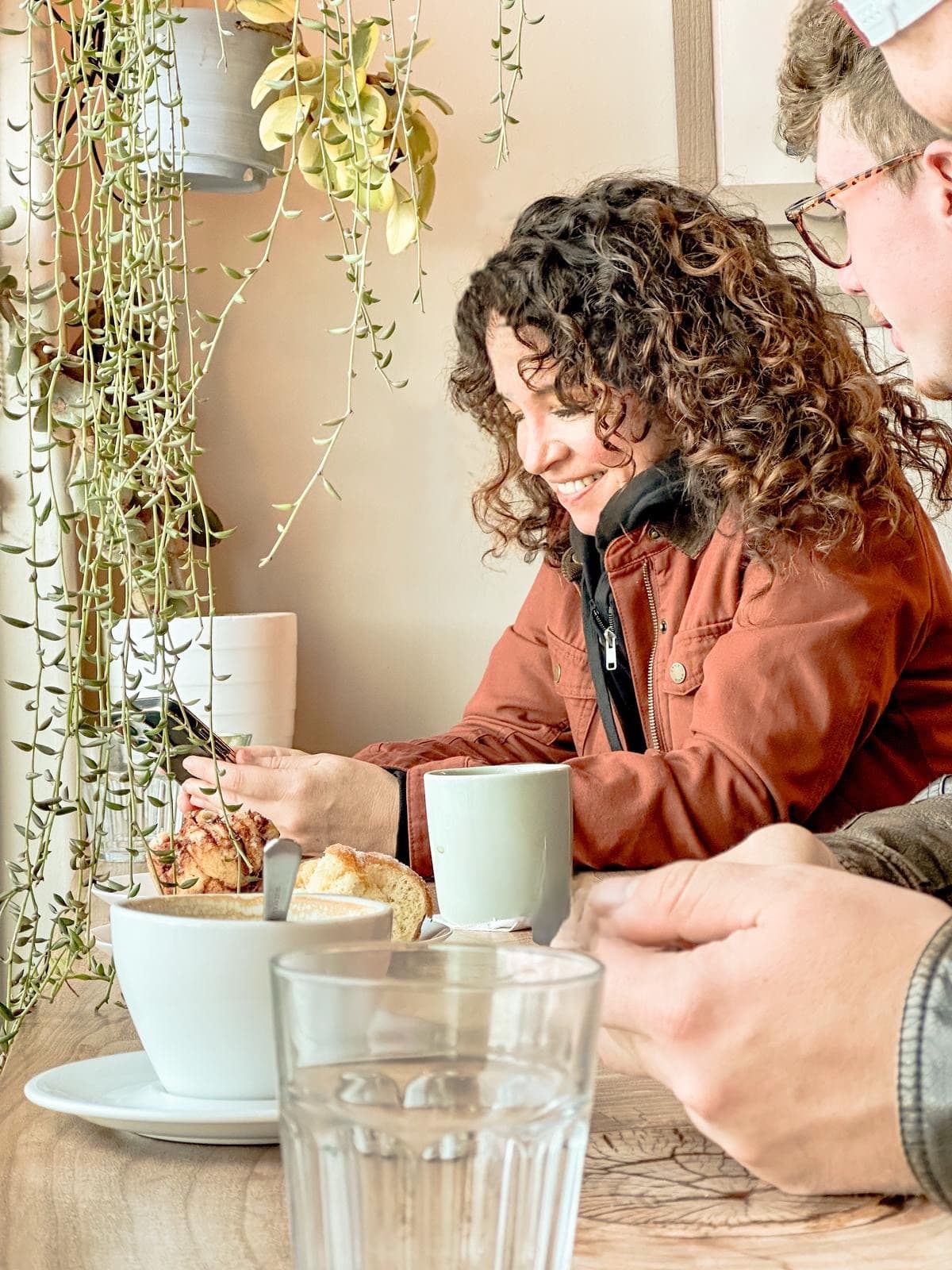 Christin enjoying coffee and pastries at Manna Bakery