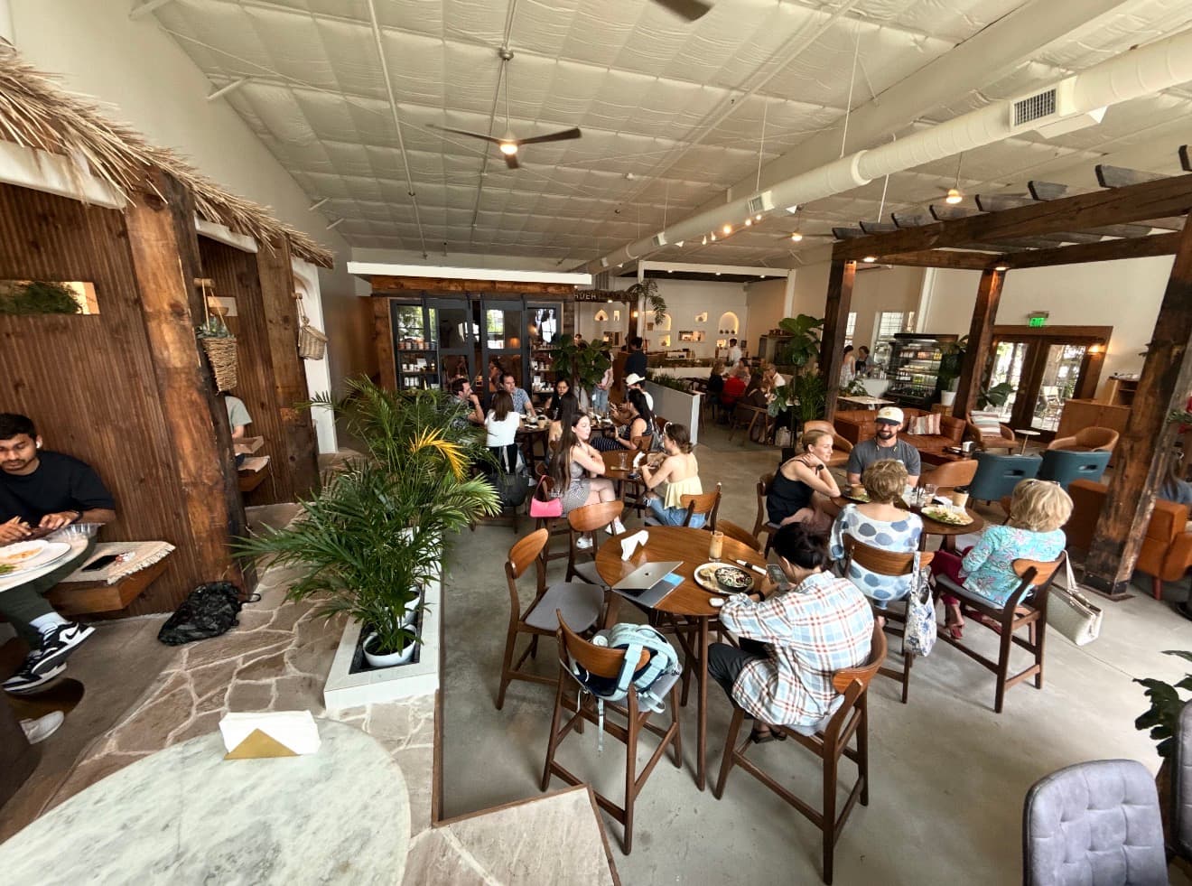 A lively day inside Manna Bakery with guests and team members throughout the cafe