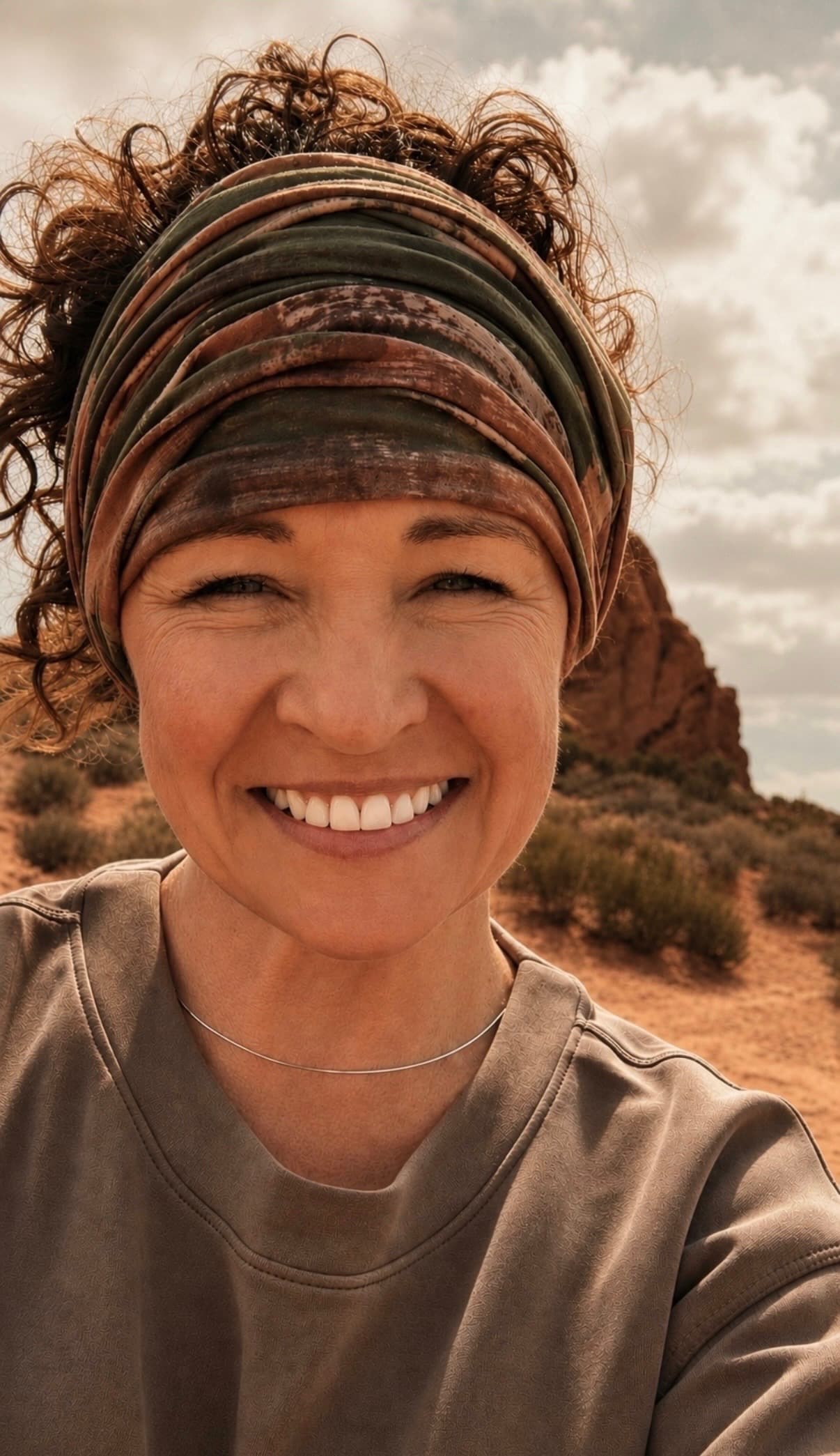 Christin, founder of Manna Bakery, smiling outdoors in the desert
