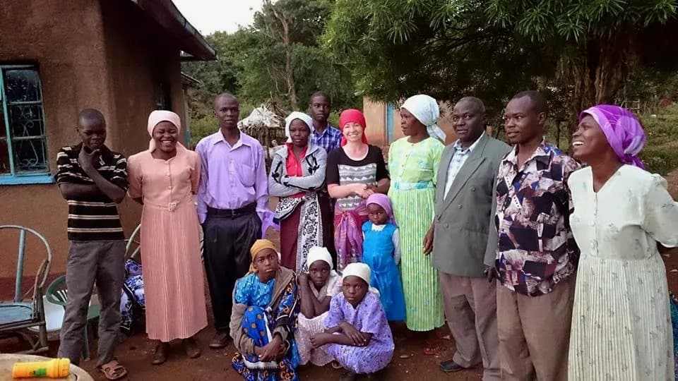 Christin gathered with a family and community in Kenya