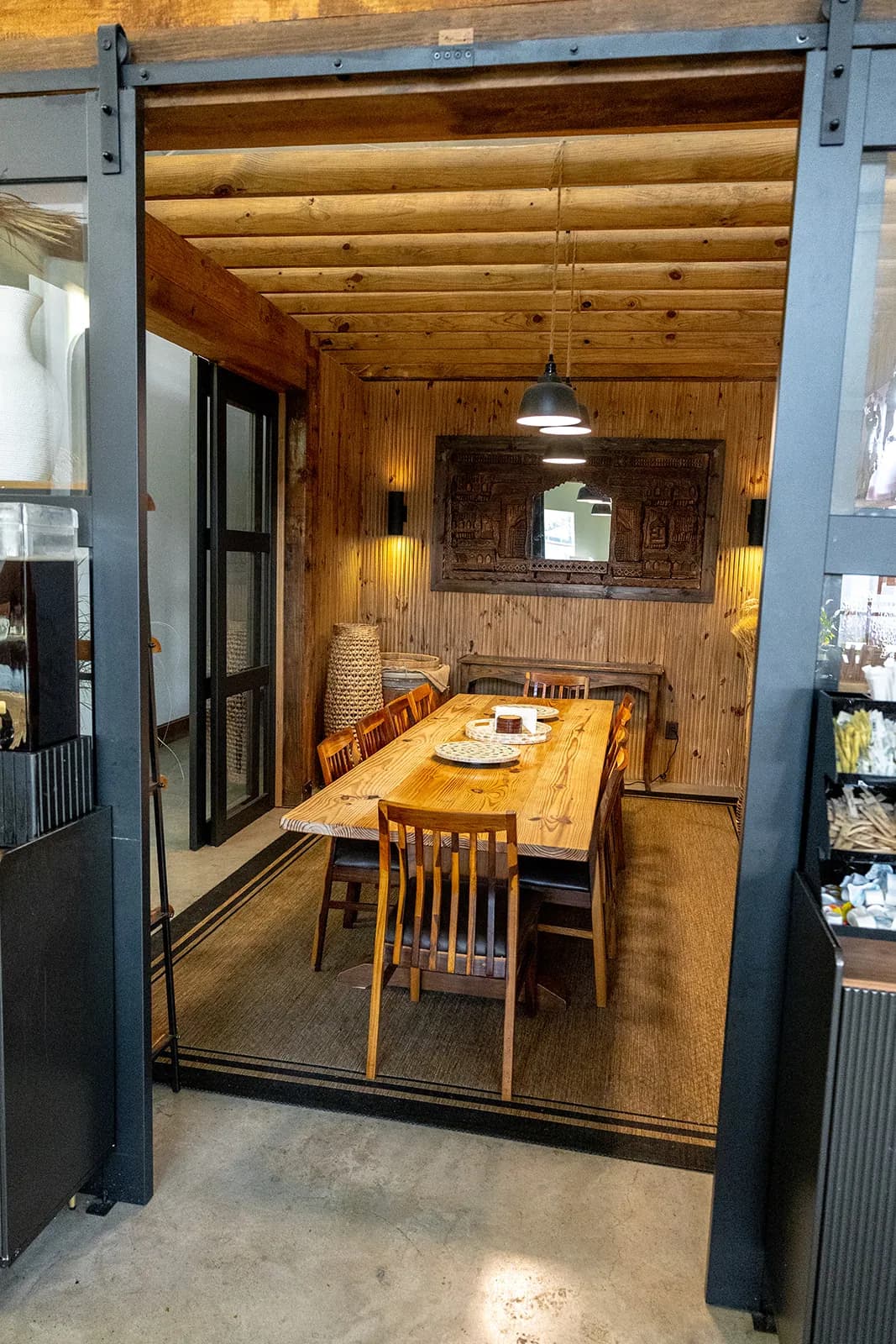 Manna Bakery conference room with wood panel walls and community table